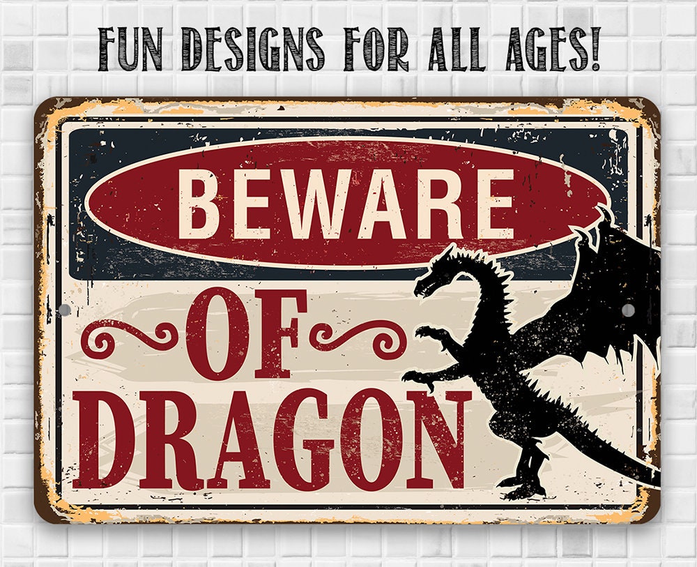 “BEWARE OF DRAGON” rectangular metal sign with dragon silhouette on white wall