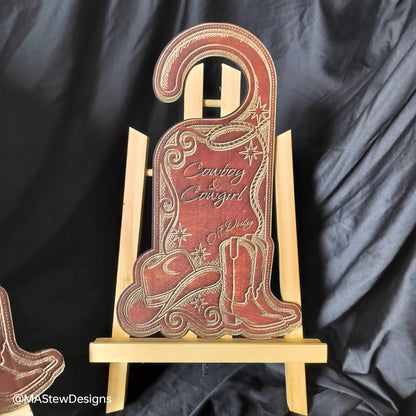 Wood door hanger with cowboy boot design and 'Cowboy Cowgirl' text.