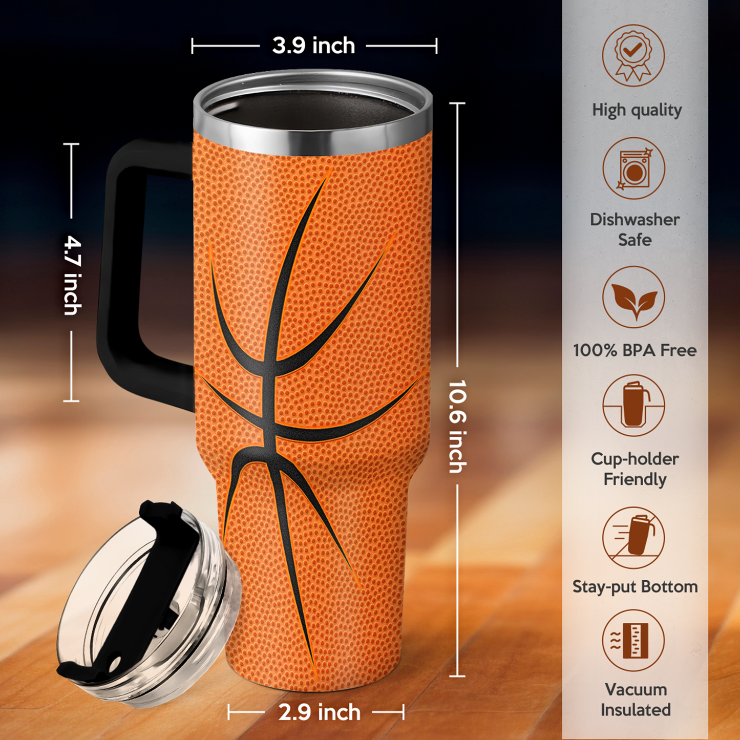 Orange basketball tumbler with black handle, clear lid, and vacuum-insulated design