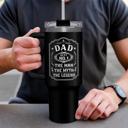 Black 40oz tumbler with handle held in hands; white Dad graphic on front