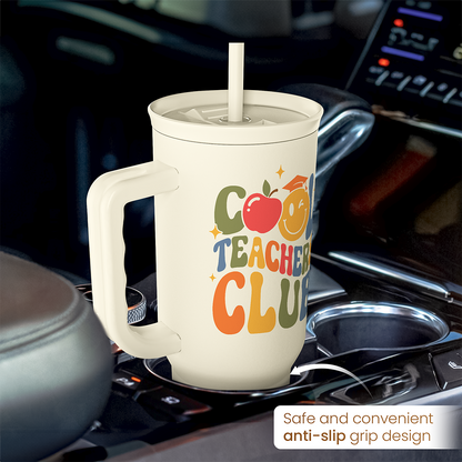 Beige Teachers Club tumbler on stovetop, handle with anti-slip grip design