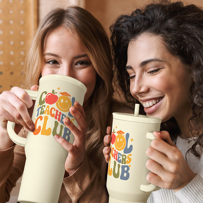 Two people holding beige Teachers Club tumblers with straw and handle
