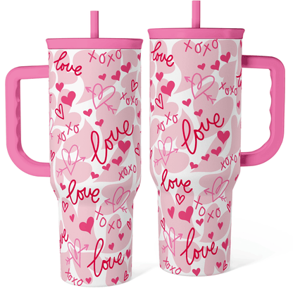 Pink 40oz tumbler with handle, white body with pink hearts and love scribble pattern.