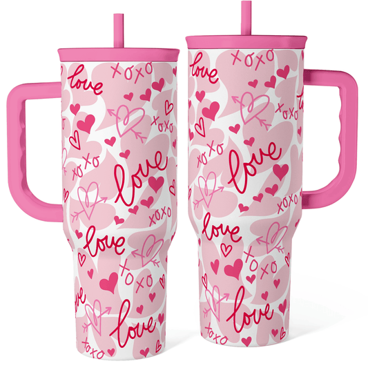 Pink 40oz tumbler with handle, white body with pink hearts and love scribble pattern.