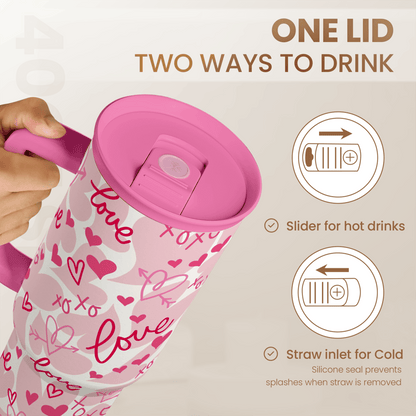 Pink 40oz tumbler with slider lid and straw inlet, white with pink hearts love pattern.