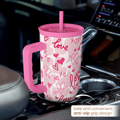 Pink 40oz tumbler with handle and straw, white with pink hearts and love pattern.
