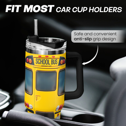 Yellow school bus tumbler with clear lid and black handle, ready to sip