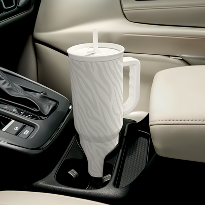 Zebra-print 40oz tumbler with straw resting in a car cup holder