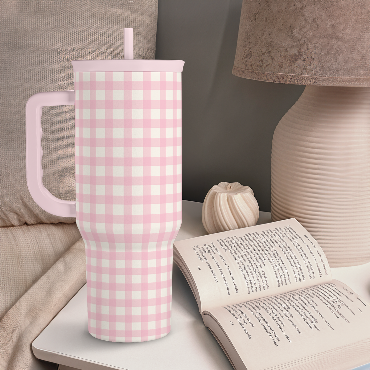 Pink gingham tumbler with lid and straw standing upright