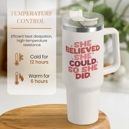 White 40oz tumbler with handle, red slogan graphic, lid with straw top.