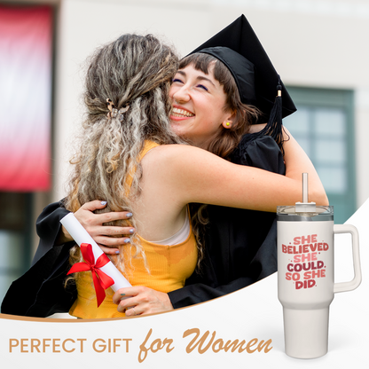 White 40oz tumbler with handle and red slogan graphic beside a graduate gift.