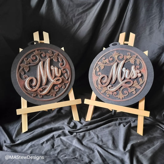 Set of 2 laser-engraved wooden chair signs with round dark bases and pale support bars