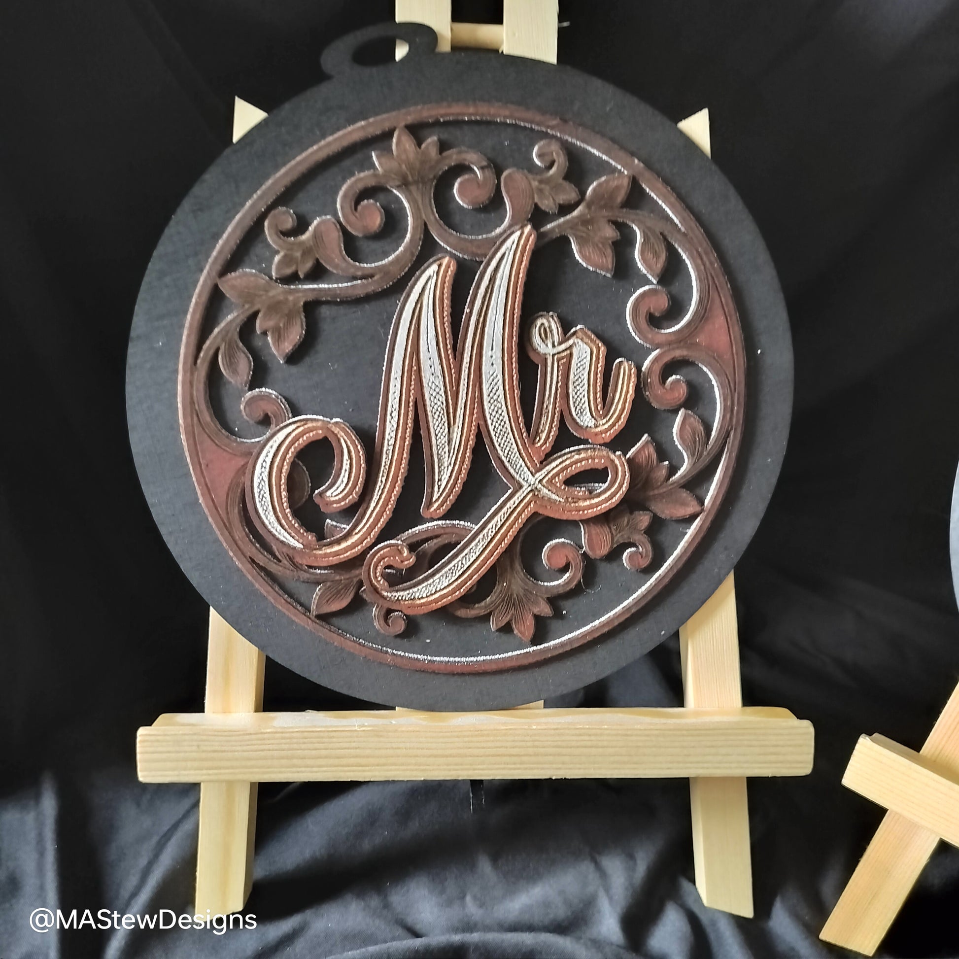 Laser-engraved wooden chair sign with round dark base and ornate Mr cursive