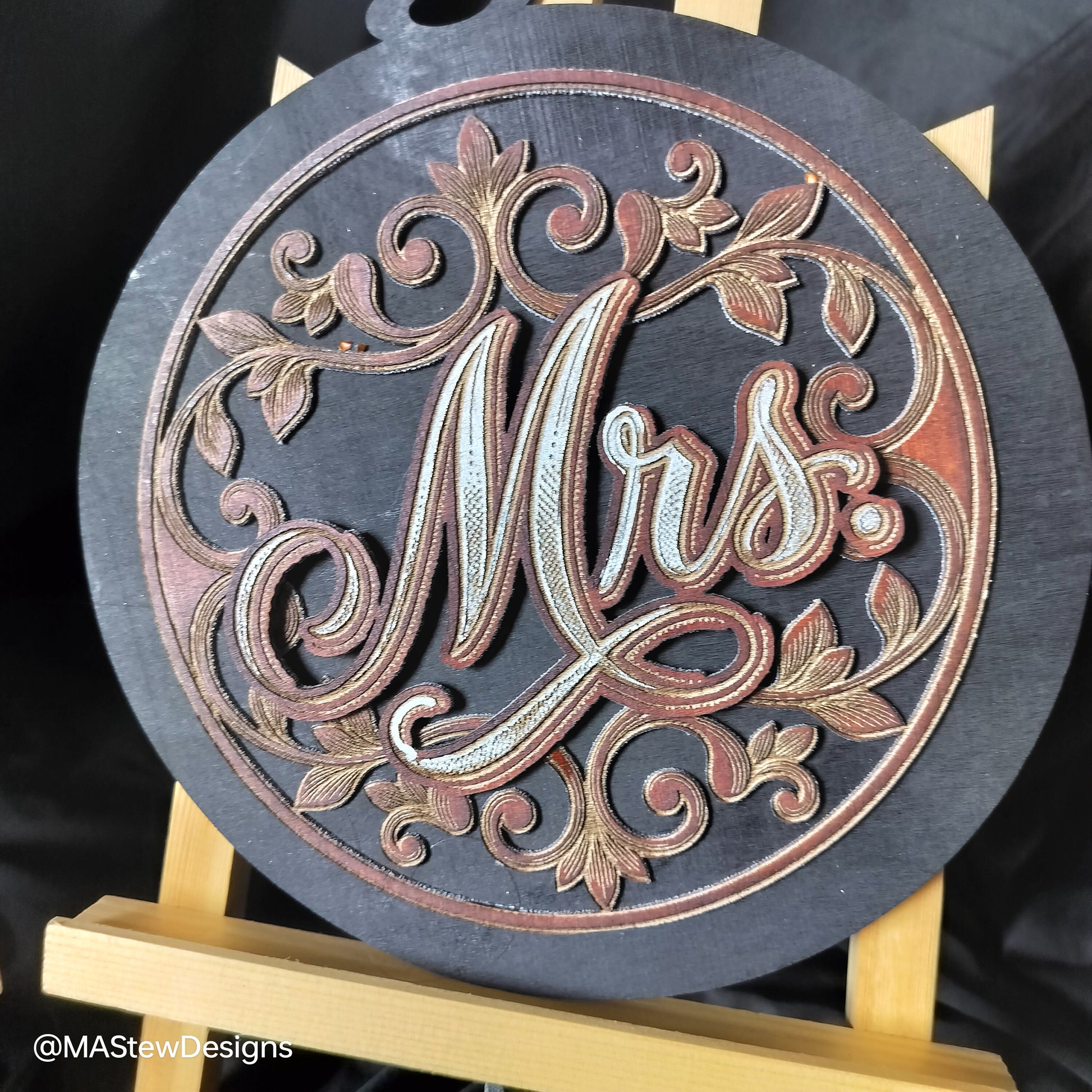 Laser-engraved wooden chair sign with round dark base and ornate Mrs cursive