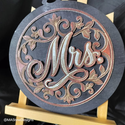 Laser-engraved wooden chair sign with round dark base and ornate Mrs cursive