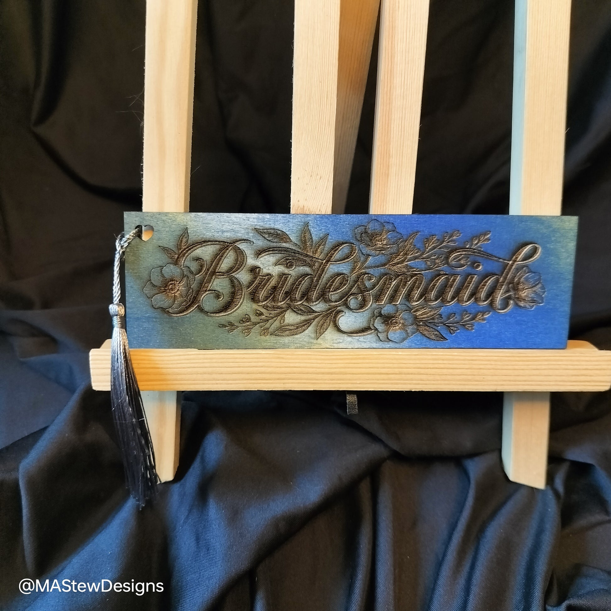 Blue wood bookmark with engraved floral script and black tassel
