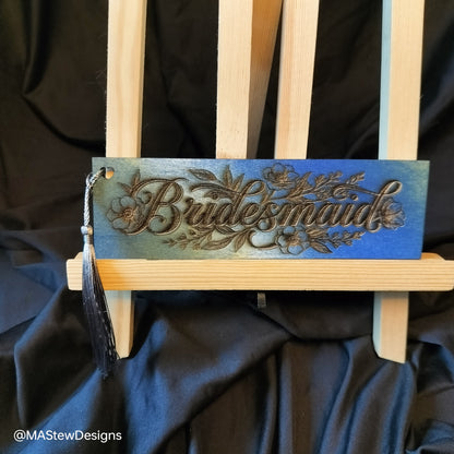 Blue wood bookmark with engraved floral script and black tassel