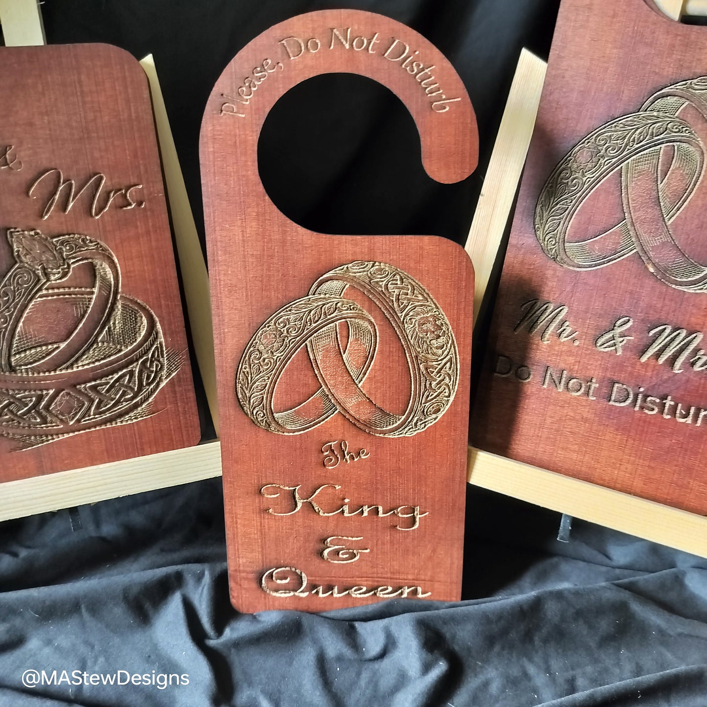 Wood door hanger with ring motif and 'The King & Queen' text.