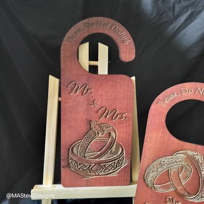Wood door hanger with Mr and Mrs text and gold ring design.