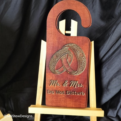 Wood door hanger with 'Mr. & Mrs' and 'Do Not Disturb' text plus ring design.