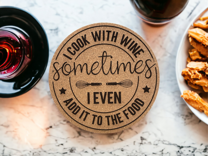 Round cork coaster with printed 'I Cook With Wine' and 'Add it to the food' text