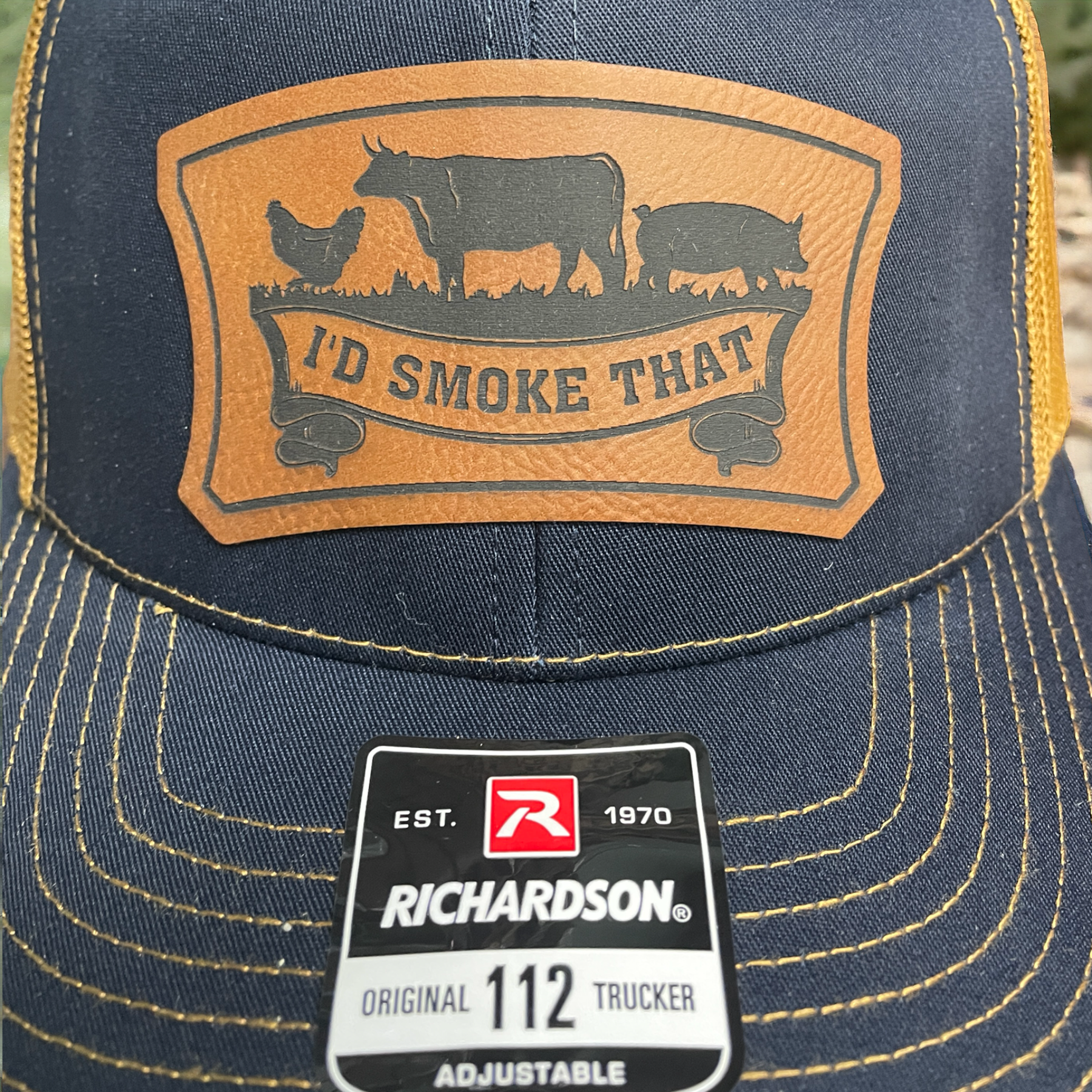 Navy trucker cap with leatherette logo patch and Richardson Original 112 adjustable badge