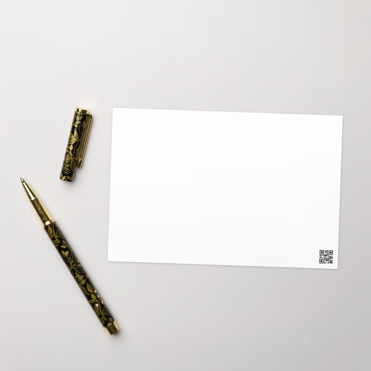 Blank white greeting card back with small QR code at the bottom right