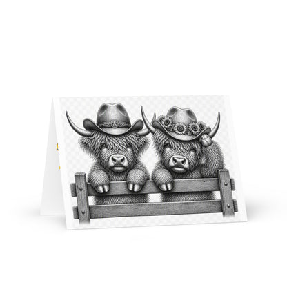 Greeting card front with two grayscale cowboy cows wearing hats on a fence