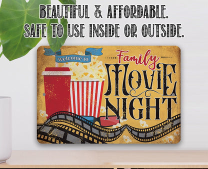 Rectangular metal sign reading "Welcome to Family Movie Night" with theater reel graphics