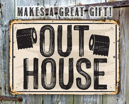 Outdoor metal sign reading “OUT HOUSE” with distressed black lettering and icons