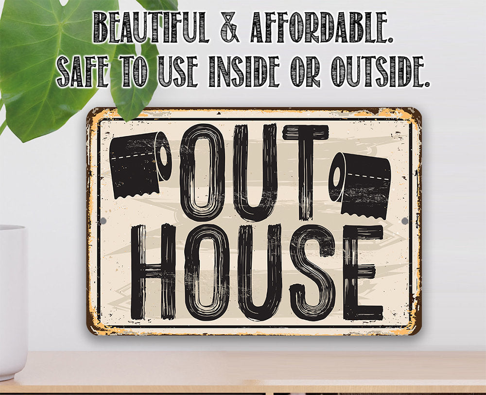 Metal sign reading “OUT HOUSE” with distressed black-and-cream lettering and icons