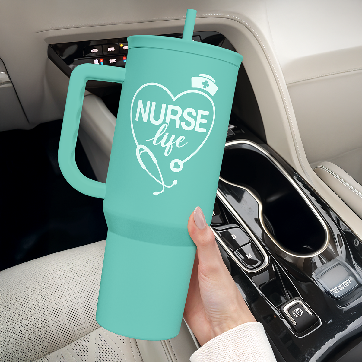 Mint nurse tumbler with handle and straw lid held near car console