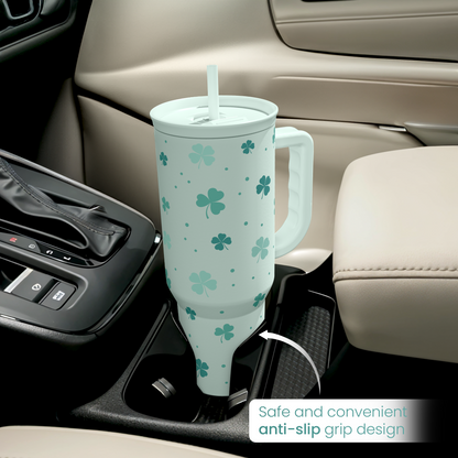 Mint green 40oz slide tumbler with handle in car cupholder, shamrock clover pattern