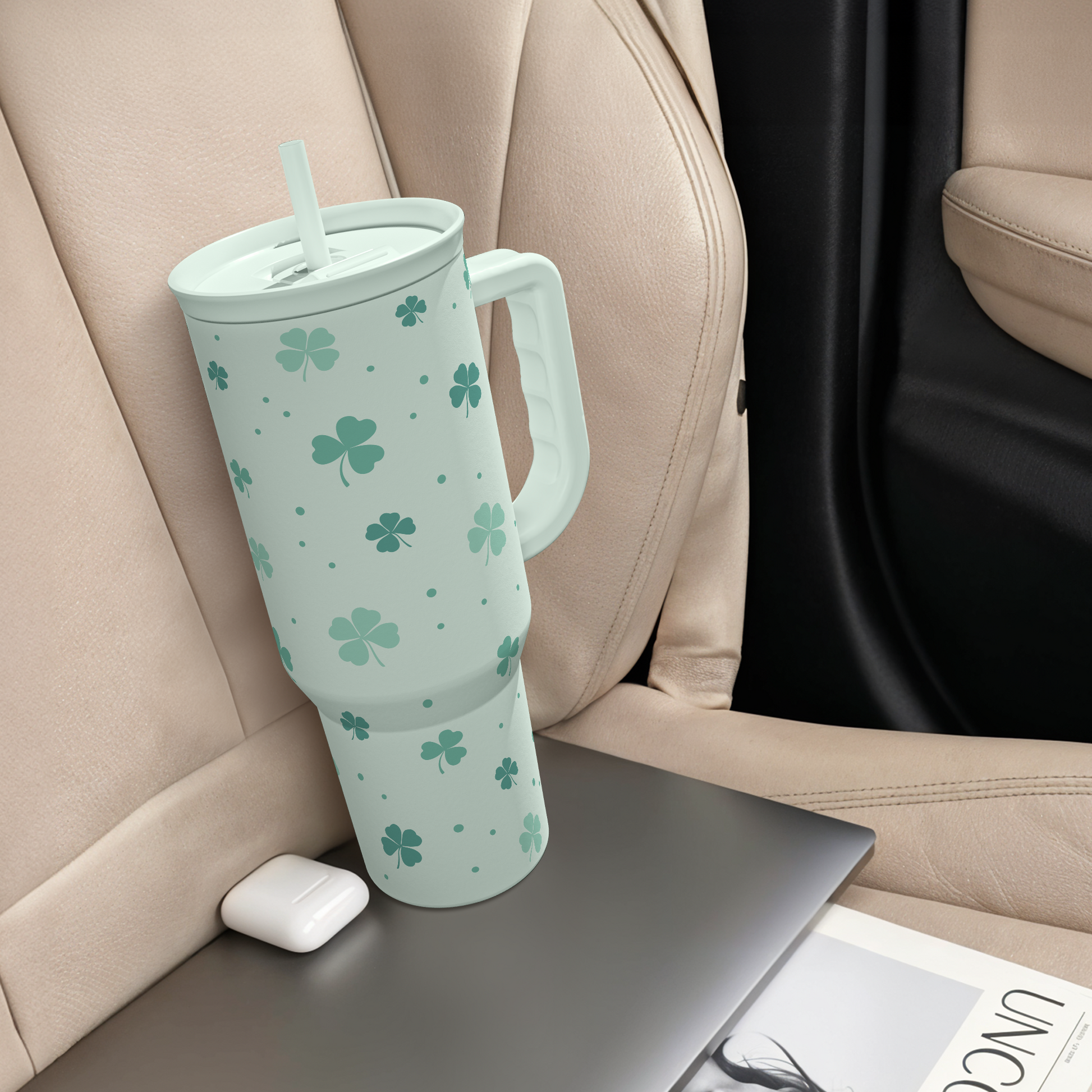 Mint green 40oz slide tumbler with handle on car seat console, shamrock clover pattern