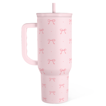 Pink 40oz tumbler with handle and lid, bow pattern and matching straw