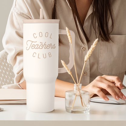White 40oz tumbler with straw and “Cool Teachers Club” logo, on tabletop