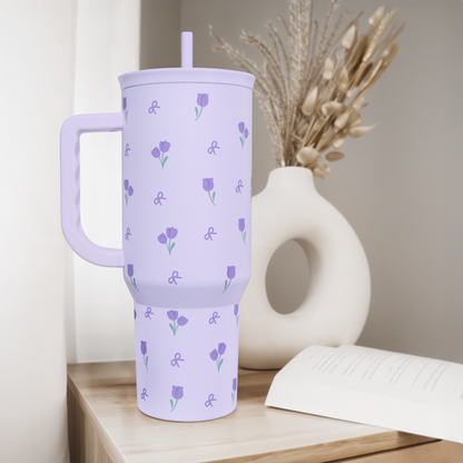 Purple floral 40oz tumbler with lid and straw, standing with handle for easy carry