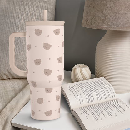 40oz slider tumbler with handle in beige, brown bear print, straw, on tabletop