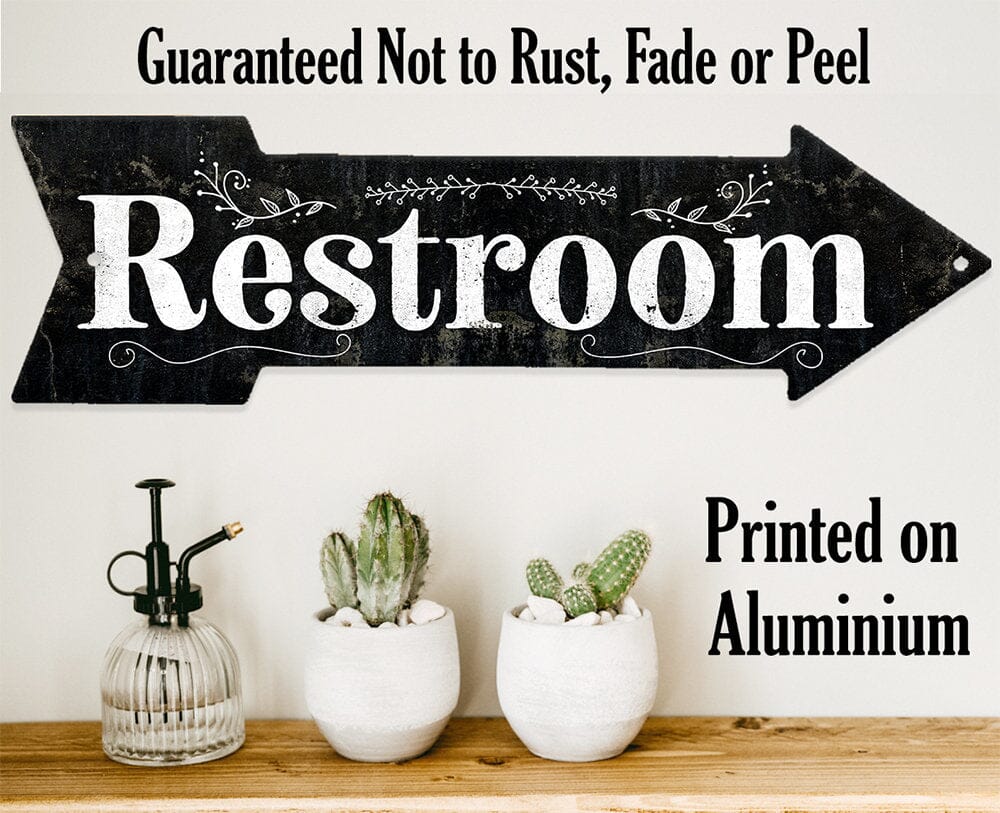 Restroom directional arrow metal sign; text reads “Guaranteed Not to Rust”