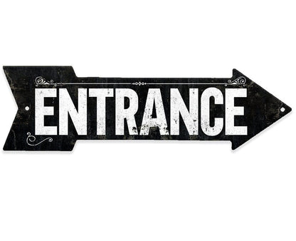 Black metal directional arrow sign reading 'ENTRANCE' with ornate corner scroll details
