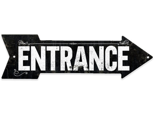 Black metal directional arrow sign reading 'ENTRANCE' with ornate corner scroll details