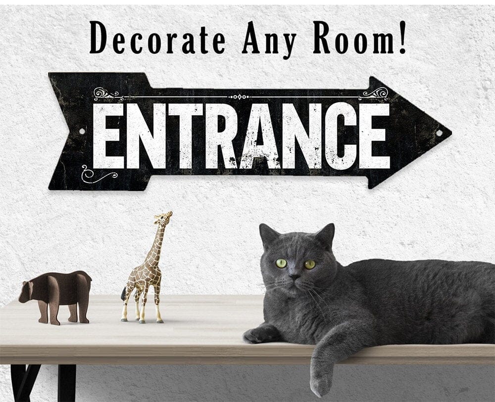 Black metal 'ENTRANCE' directional arrow sign with decorative corner flourishes and holes