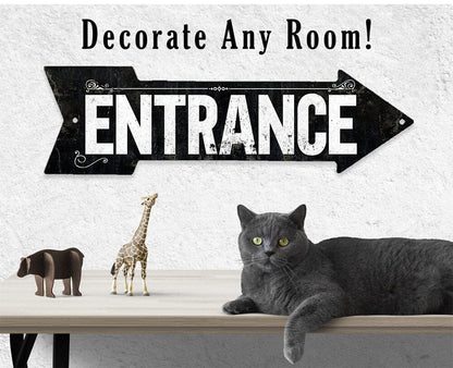 Black metal 'ENTRANCE' directional arrow sign with decorative corner flourishes and holes