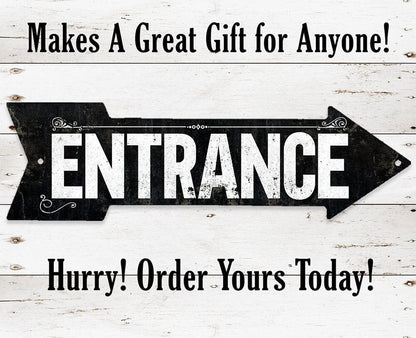 Black 'ENTRANCE' arrow sign with decorative scrolls and mounting holes
