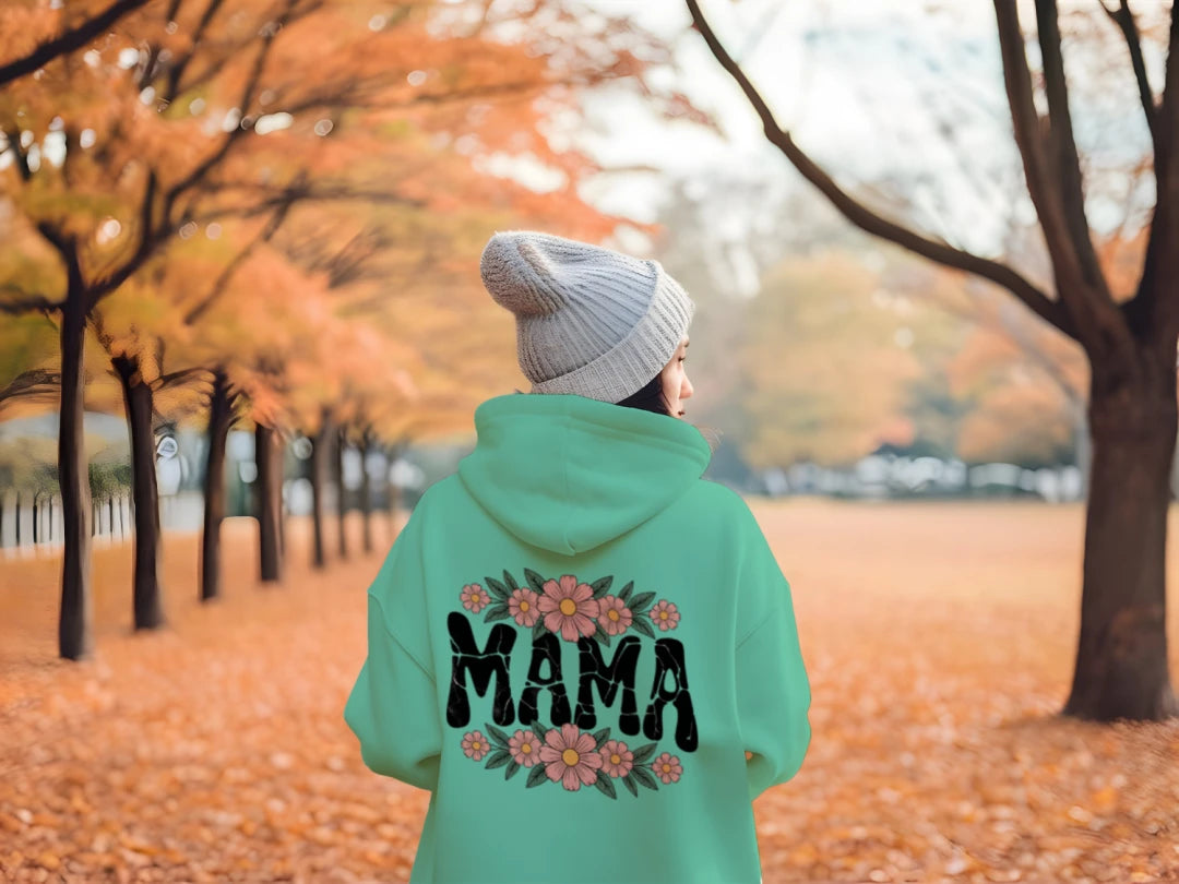 Mint green hoodie with hood up and floral crackle “MAMA” graphic on back
