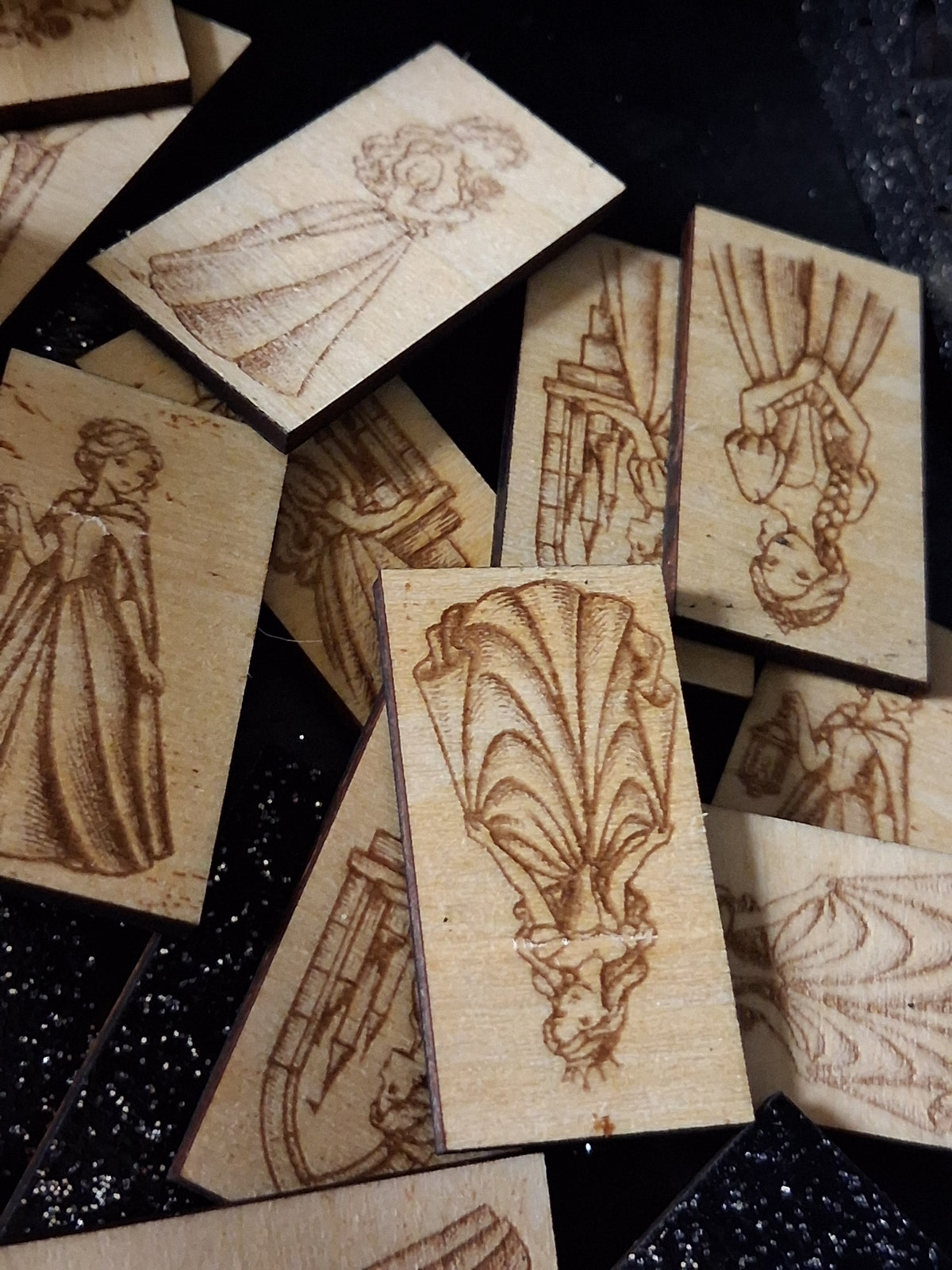 Set of light wood memory game cards with engraved princess-themed figures