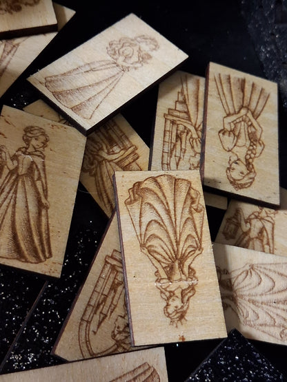 Set of light wood memory game cards with engraved princess-themed figures