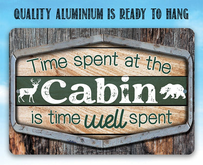 Cabin metal sign with green background, teal “Cabin” text, deer and bear silhouettes