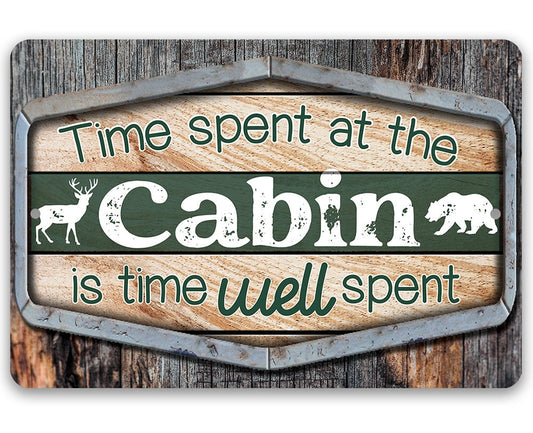 Cabin metal sign with green center, teal text, “Cabin” wordmark, and deer silhouettes