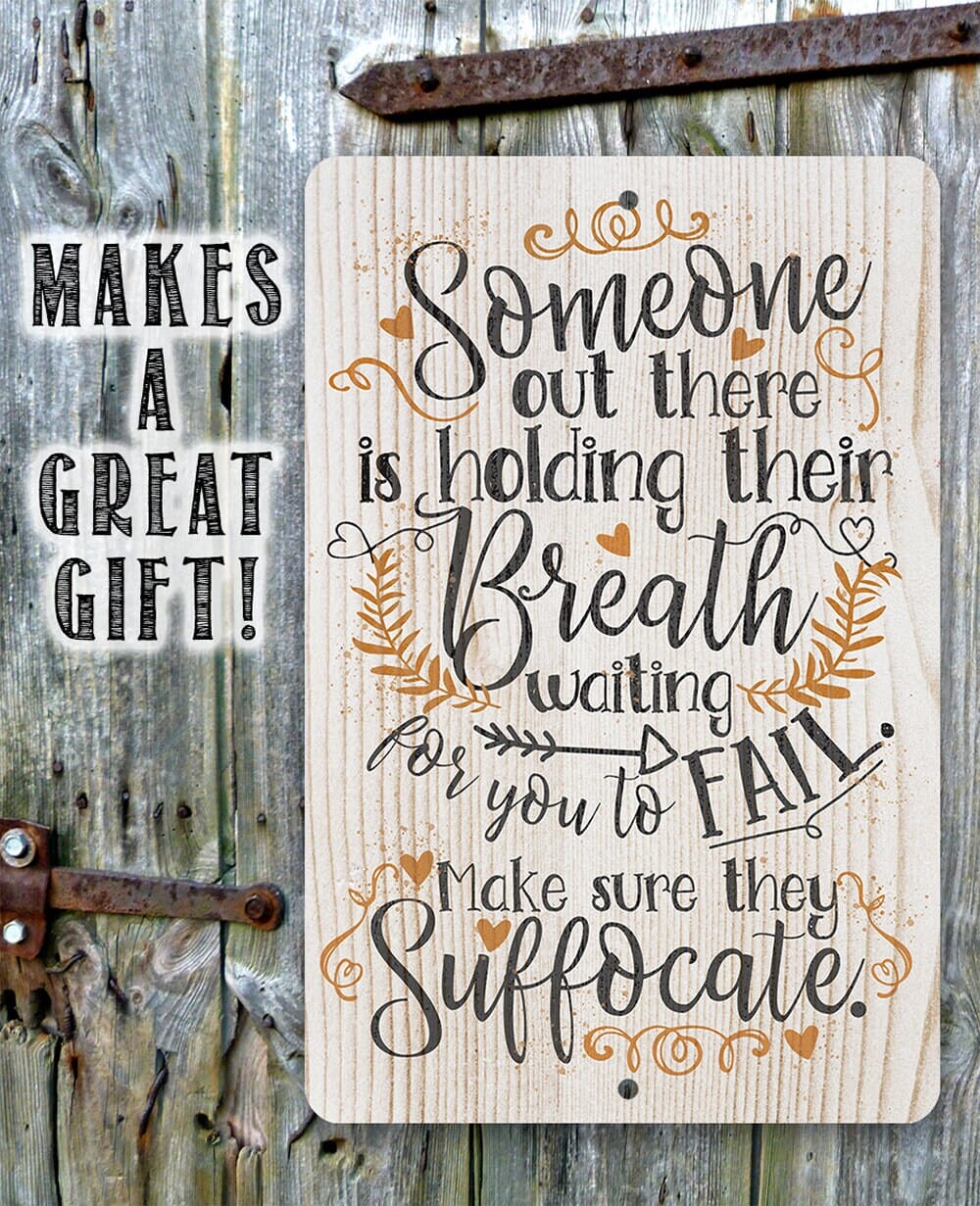 Metal sign with quote 'Someone out there is holding their Breath' in decorative tan and black